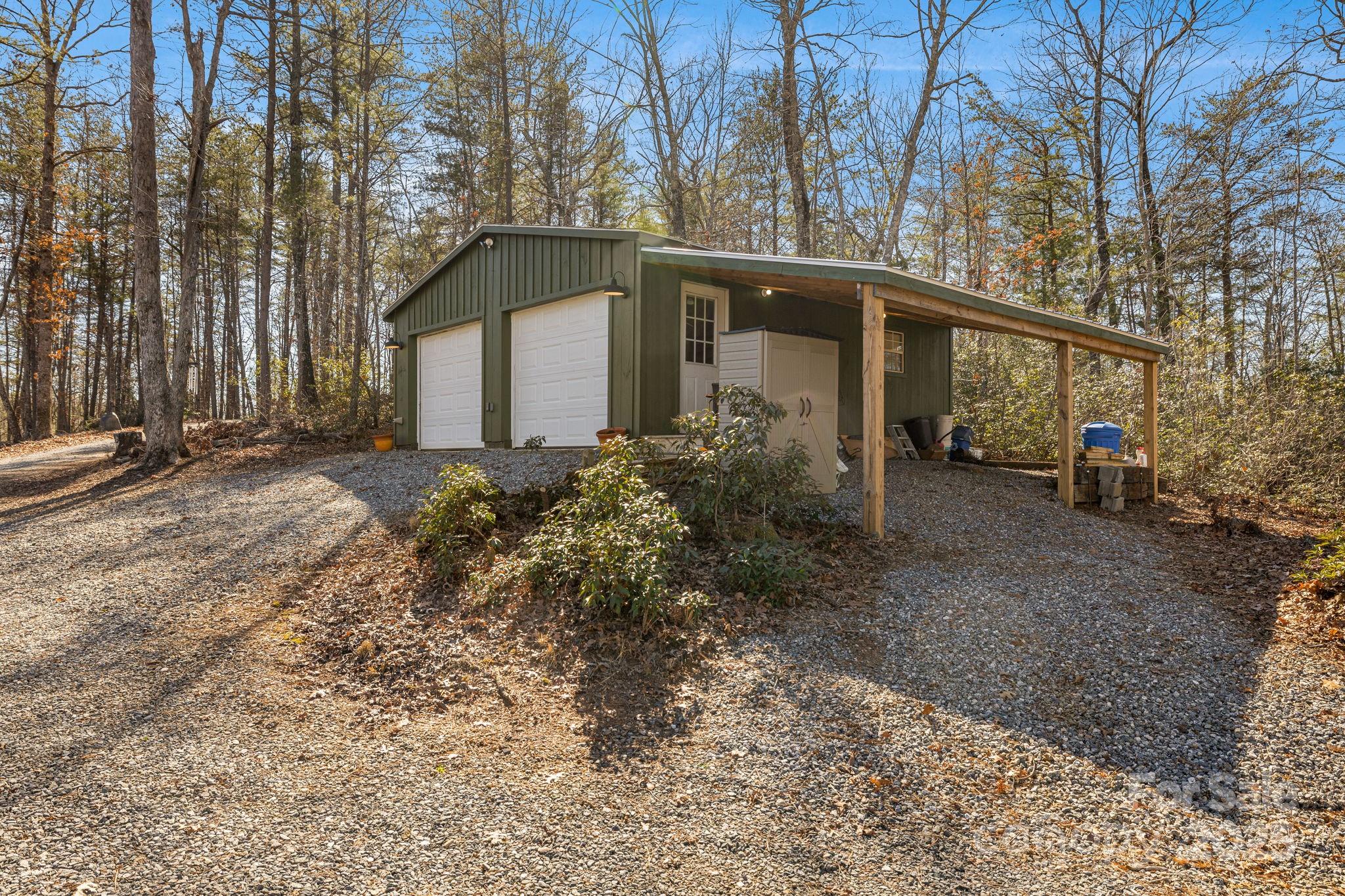 81 Delind Drive Mill Spring, NC 28756 - Photo 35 of 40 a front view of a house with garden