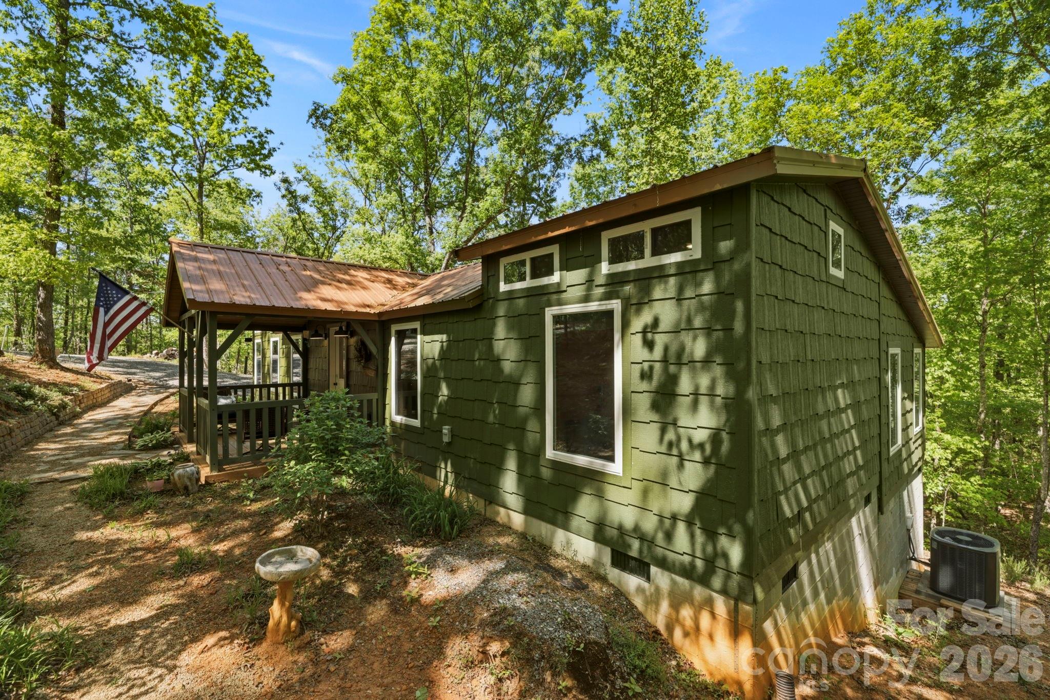 81 Delind Drive Mill Spring, NC 28756 - Photo 37 of 40 a front view of a house with garden
