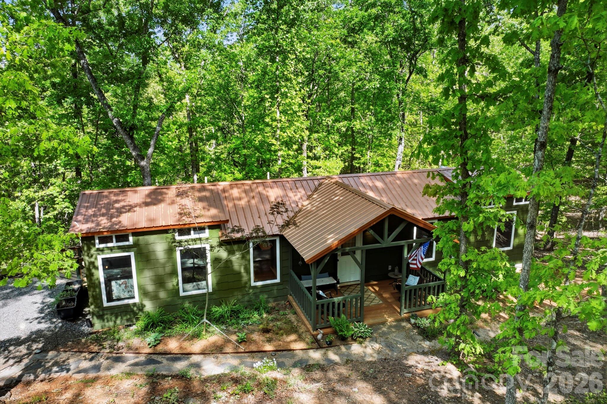 81 Delind Drive Mill Spring, NC 28756 - Photo 5 of 40 an aerial view of a house with a yard table and chairs
