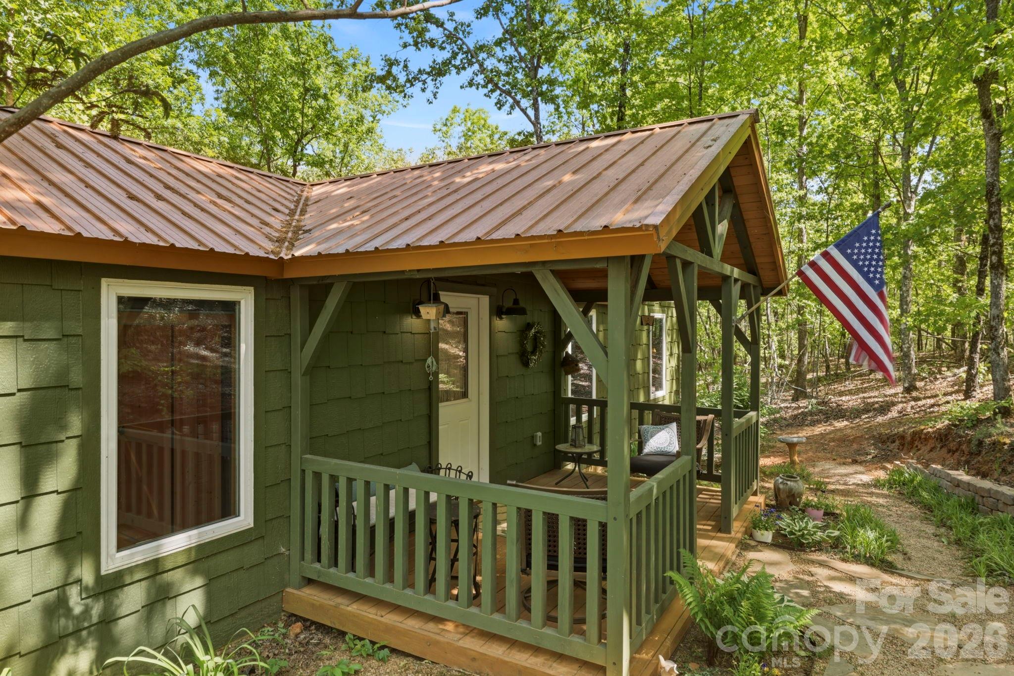 81 Delind Drive Mill Spring, NC 28756 - Photo 6 of 40 a view of barn with large trees and wooden fence