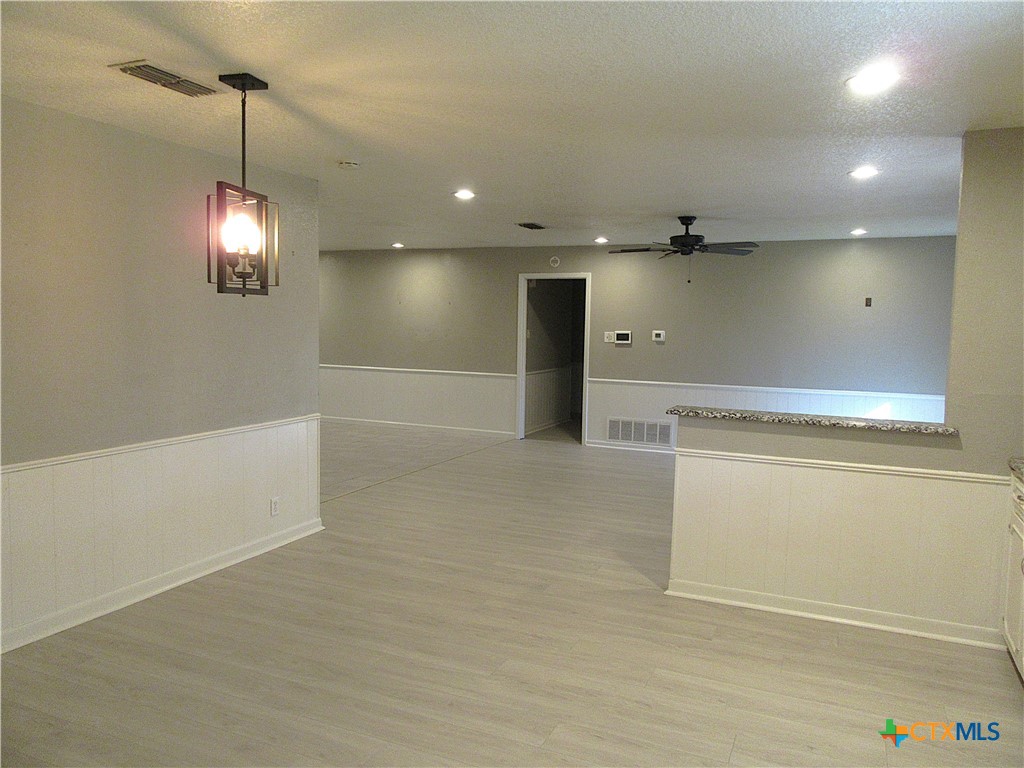 4113 Fox Trail Temple, TX 76504 - Photo 11 of 30 en empty room with windows and refrigerator