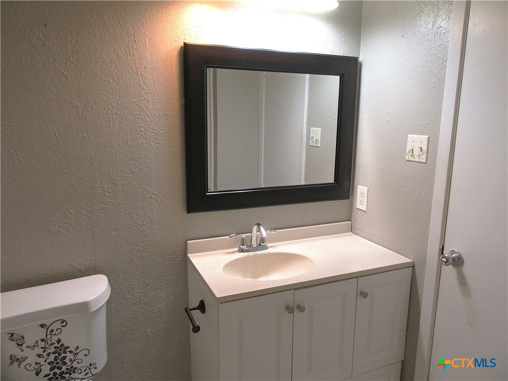 4113 Fox Trail Temple, TX 76504 - Photo 13 of 30 a bathroom with a toilet sink and mirror