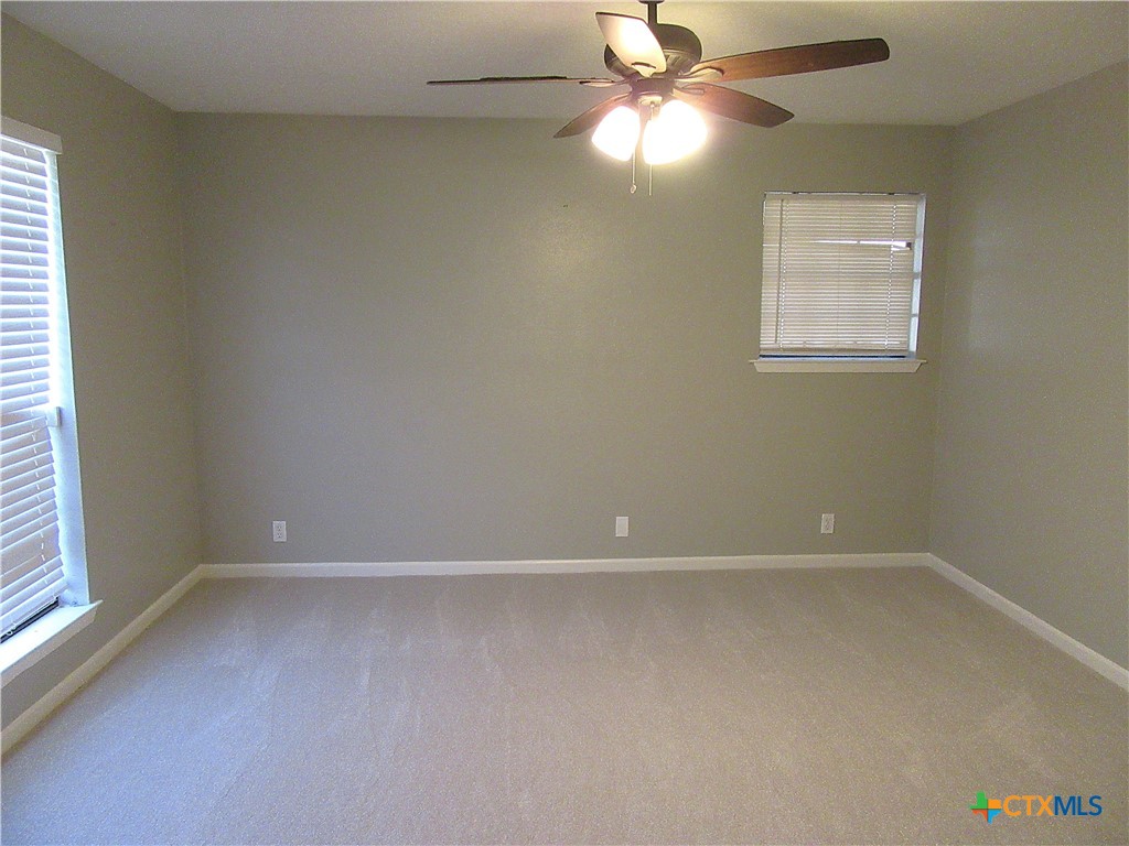 4113 Fox Trail Temple, TX 76504 - Photo 16 of 30 an empty room with windows and fan