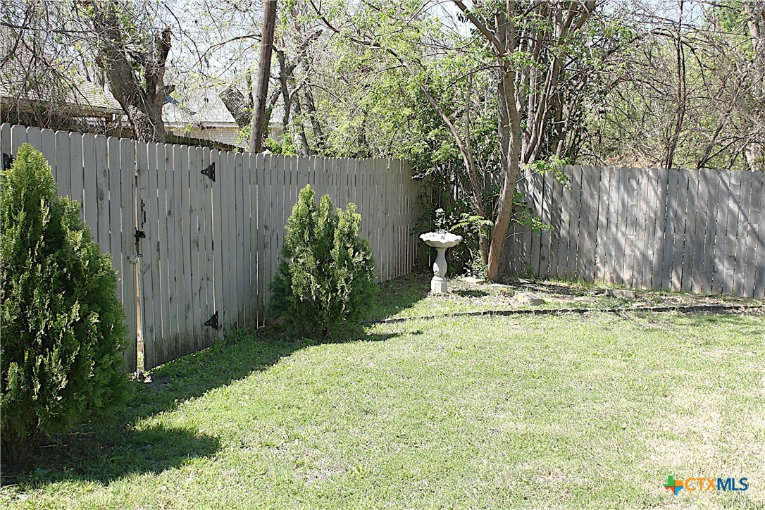 4113 Fox Trail Temple, TX 76504 - Photo 27 of 30 a view of a backyard with large trees and plants