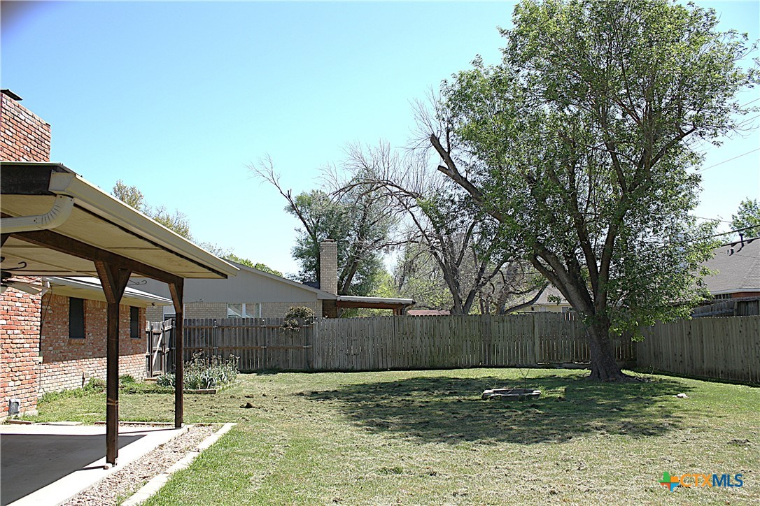 4113 Fox Trail Temple, TX 76504 - Photo 30 of 30 a view of a backyard with large trees and wooden fence