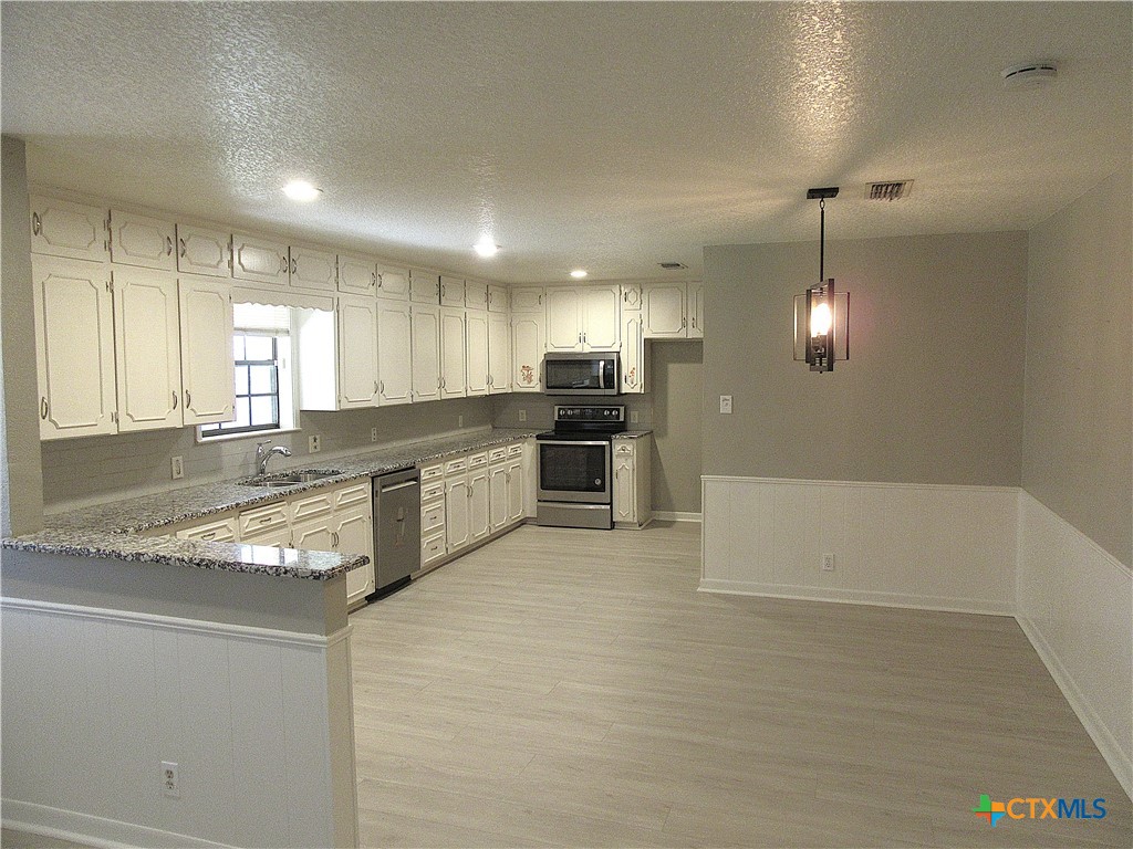 4113 Fox Trail Temple, TX 76504 - Photo 6 of 30 a large kitchen with kitchen island a sink stainless steel appliances and cabinets