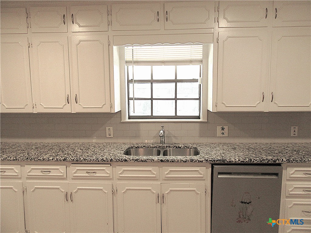 4113 Fox Trail Temple, TX 76504 - Photo 9 of 30 a kitchen with granite countertop white cabinets and a granite counter tops