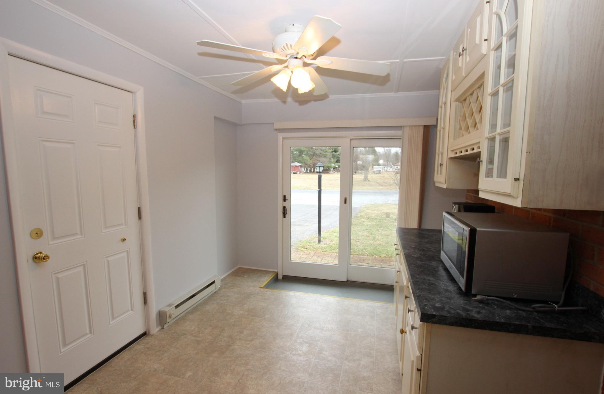 48 Apex Circle Ranson, WV 25438 - Photo 13 of 24 a view of a livingroom with furniture and a ceiling fan