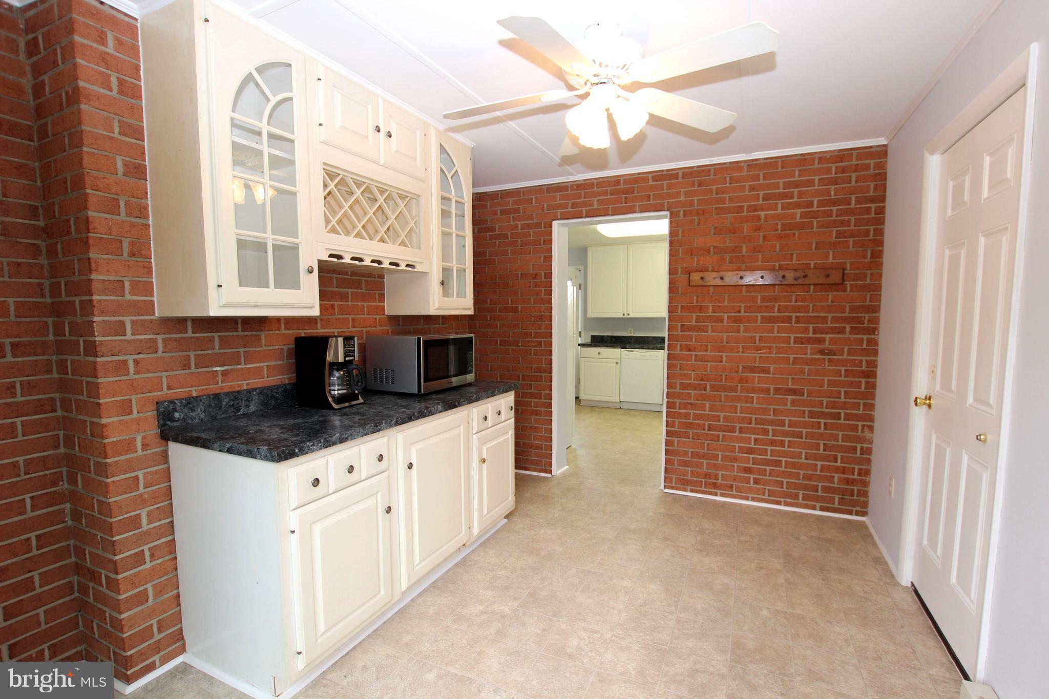 48 Apex Circle Ranson, WV 25438 - Photo 14 of 24 a kitchen with granite countertop a sink and a stove top oven