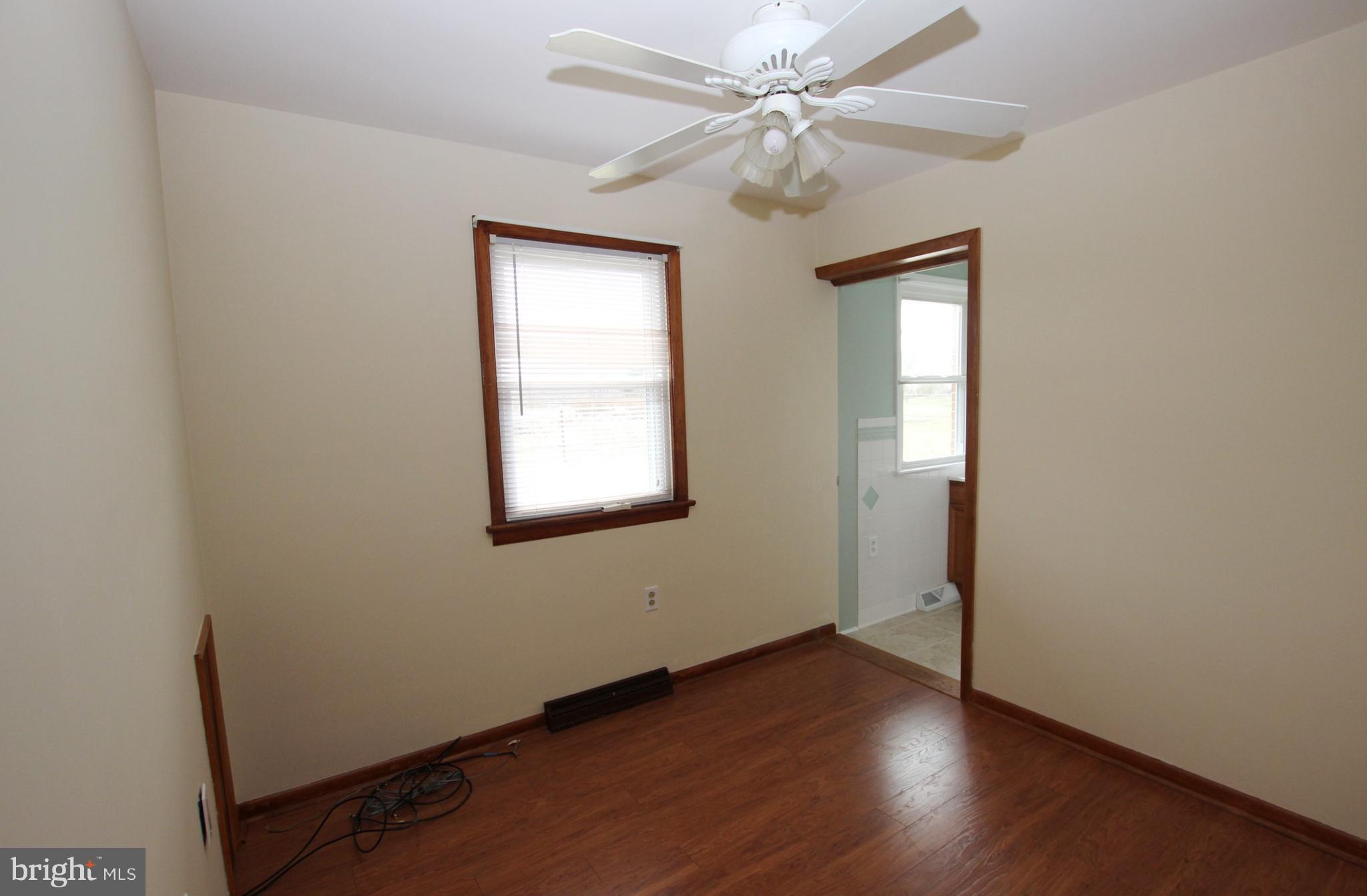 48 Apex Circle Ranson, WV 25438 - Photo 15 of 24 an empty room with wooden floor fan and windows