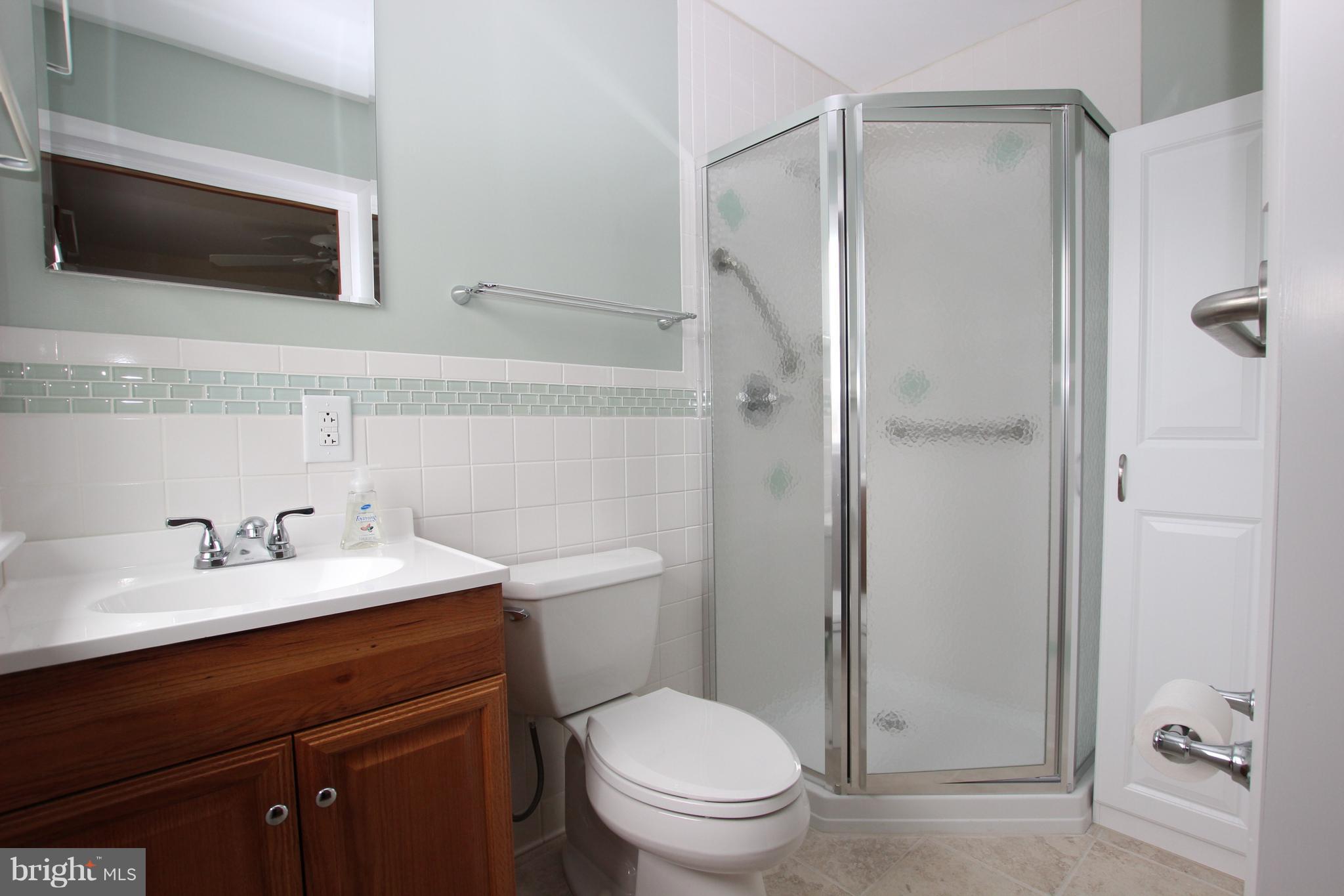 48 Apex Circle Ranson, WV 25438 - Photo 16 of 24 a bathroom with a toilet a sink a mirror and shower