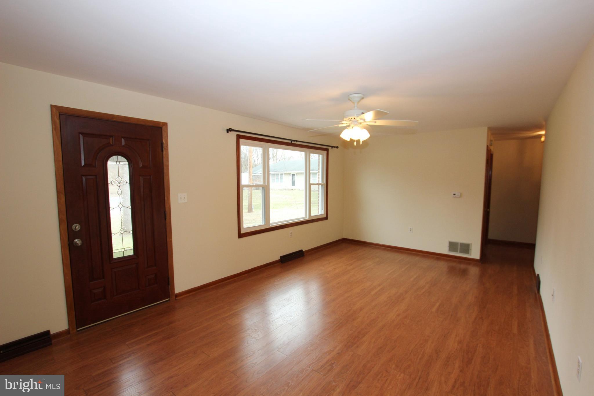 48 Apex Circle Ranson, WV 25438 - Photo 5 of 24 an empty room with wooden floor and windows