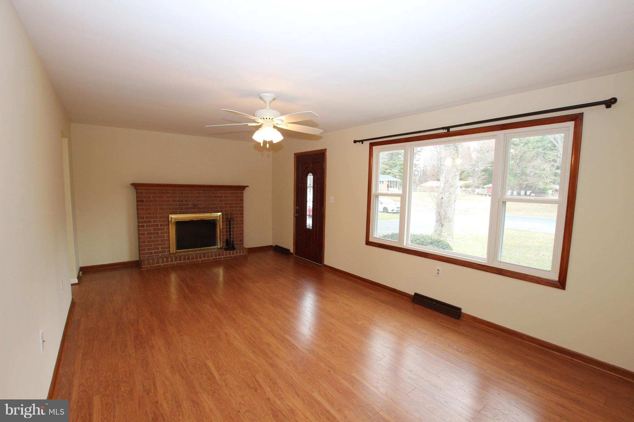 48 Apex Circle Ranson, WV 25438 - Photo 6 of 24 an empty room with wooden floor fireplace and windows