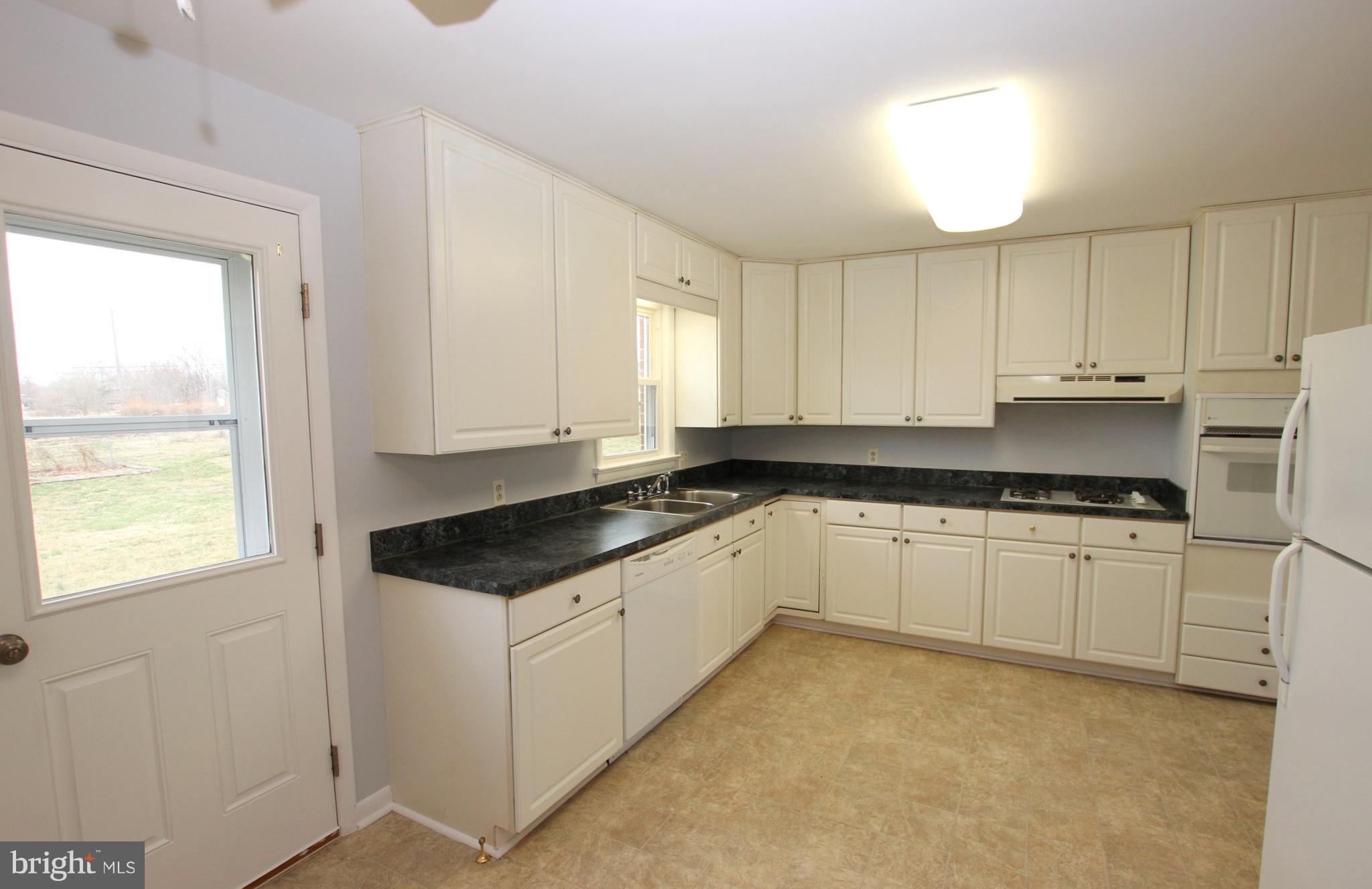 48 Apex Circle Ranson, WV 25438 - Photo 9 of 24 a kitchen with granite countertop white cabinets and white appliances