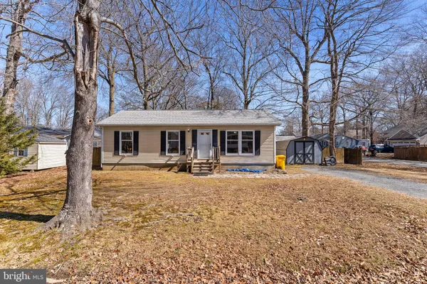 a front view of a house with a yard covered in snow