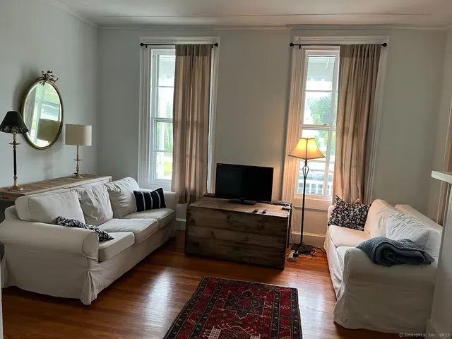 a living room with furniture and a mirror