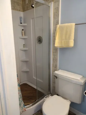 a white toilet sitting next to a bathroom sink