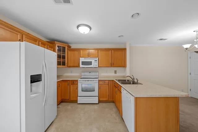 a kitchen with stainless steel appliances a refrigerator sink and stove
