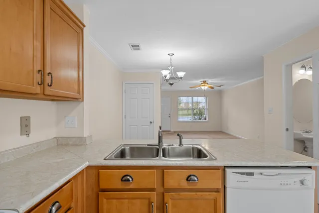 a kitchen with a sink a stove and cabinets