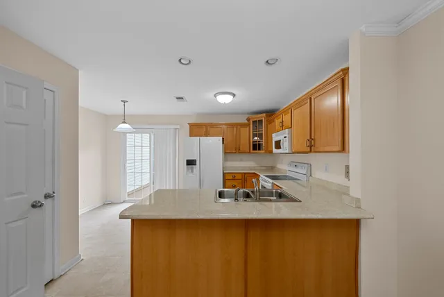 a living room with furniture a sink and a window