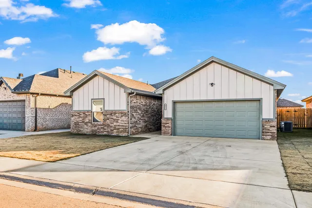 a view of a house with a yard and garage