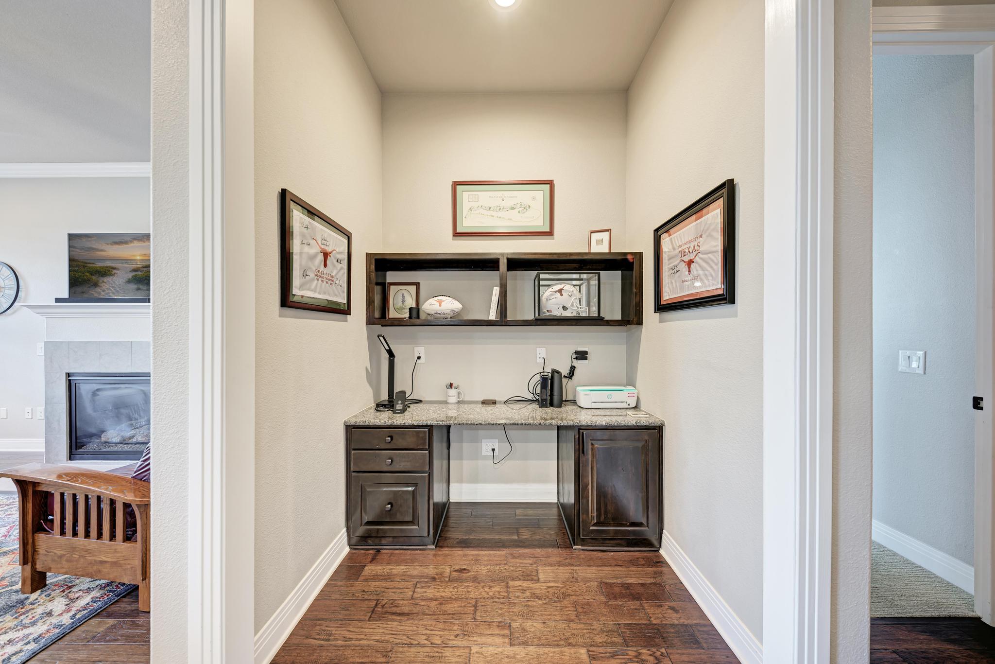 2601 North Quinlan Park Road, Unit 506 Austin, TX 78732 - Photo 22 of 39 A dedicated home office nook with warm hardwood flooring provides a functional workspace.