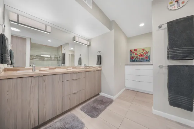 a bathroom with a sink a mirror and a shower