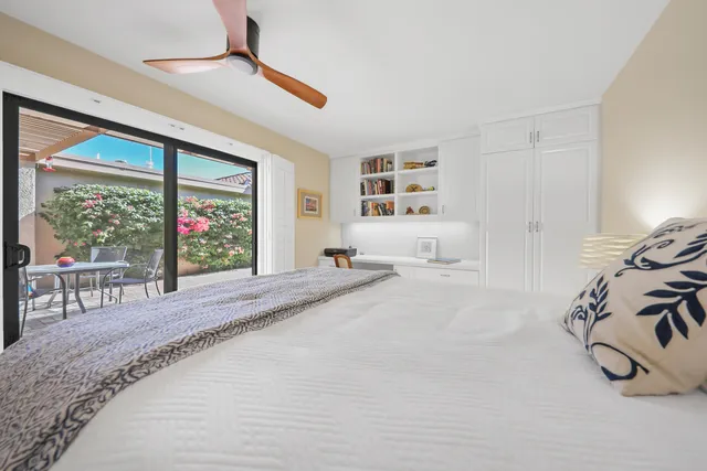 a bedroom with furniture and a large window