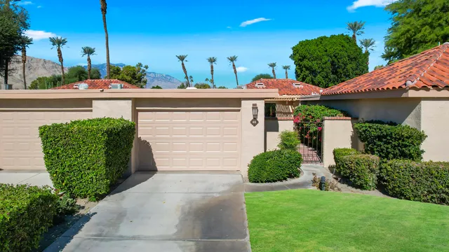 a view of a garden with a building in the background