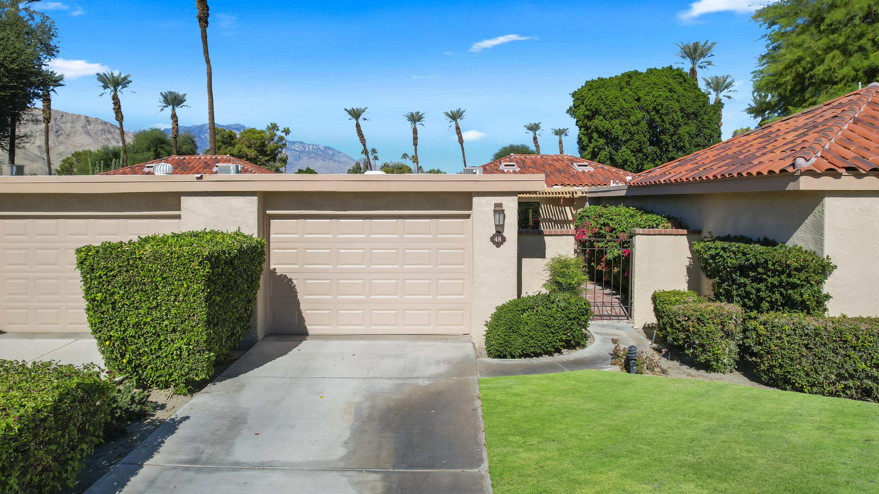 48 Palma Drive Rancho Mirage, CA 92270 - Photo 21 of 52 a front view of a house with garden