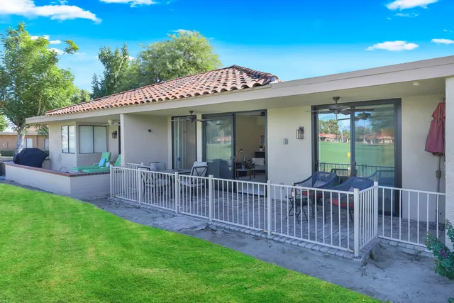a view of a house with a yard and porch