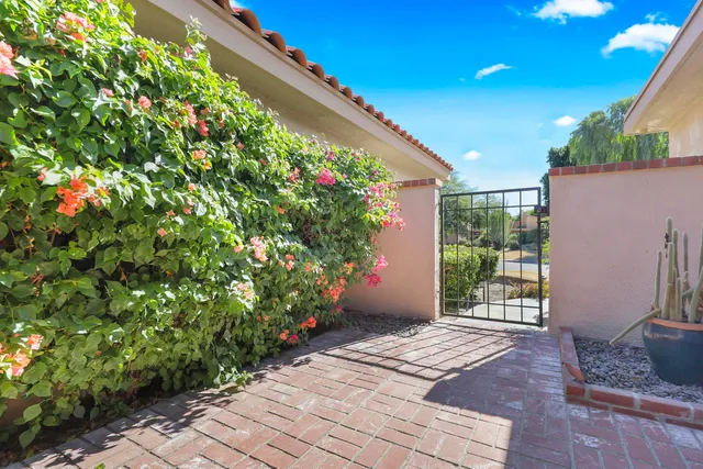 a view of an entryway with flower in front of it