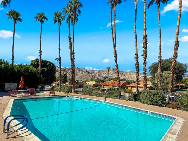 a view of a lake with chairs