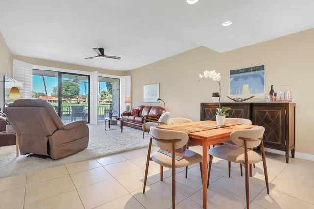 a view of a hallway with wooden floor and a living room