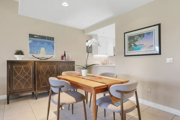 a kitchen with white cabinets stainless steel appliances and sink