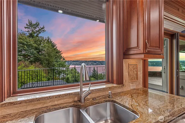 a view of a sink and tub with wooden fence
