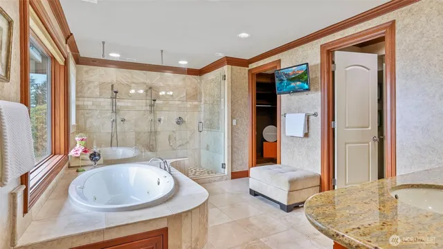 a bathroom with a tub sink and mirror