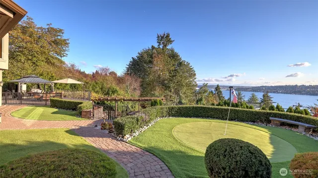 a view of a swimming pool with a patio and a yard