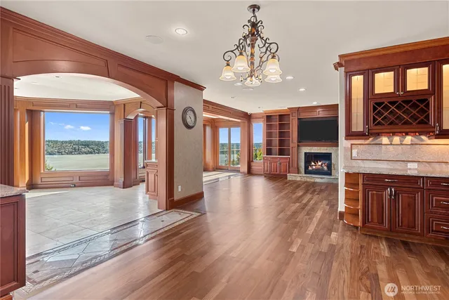 a view of a big room with wooden floor and a kitchen
