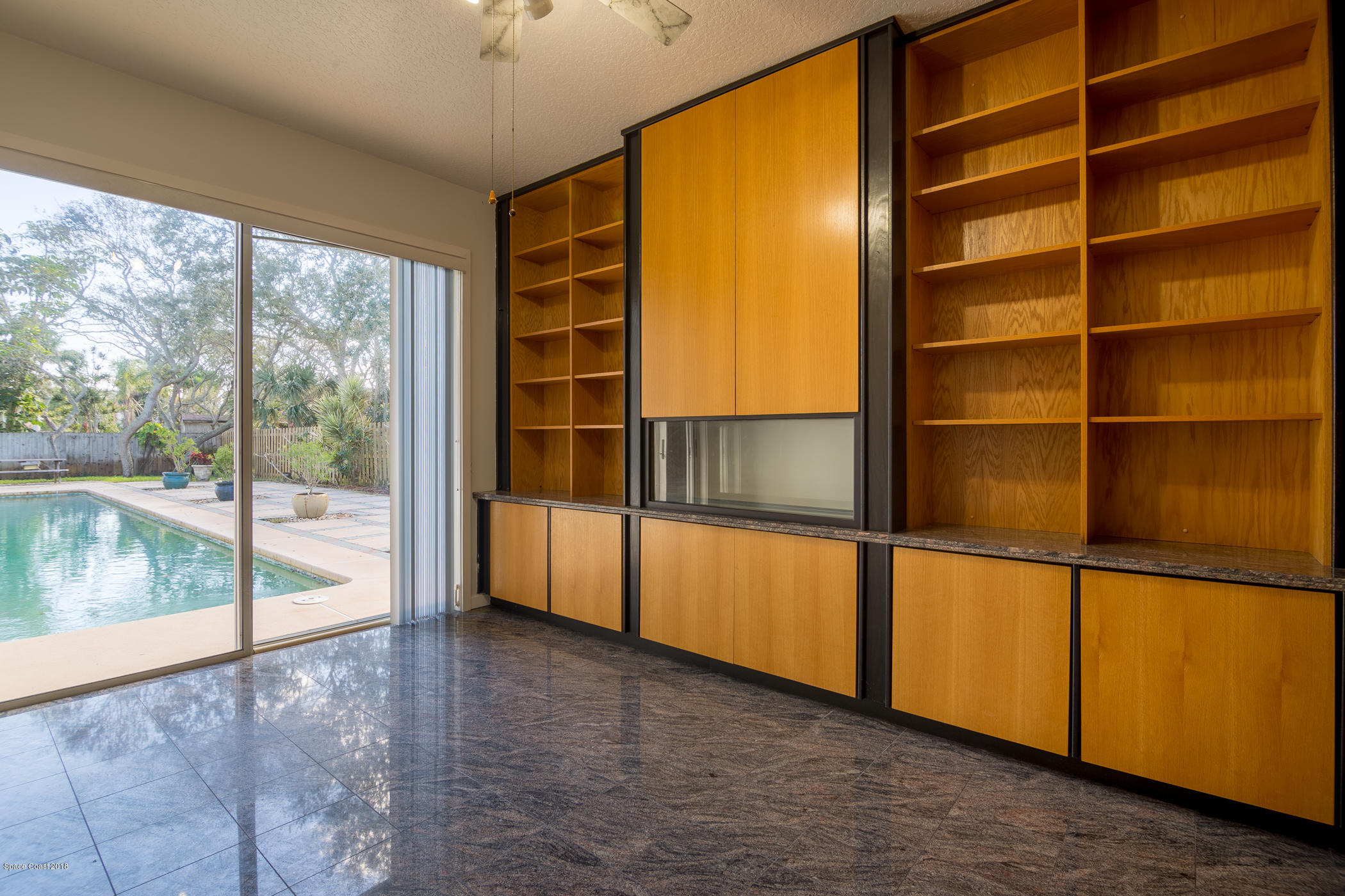 3081 Rio Baya North Melbourne, FL 32903 - Photo 11 of 31 a view of an empty room with a window and wooden floor