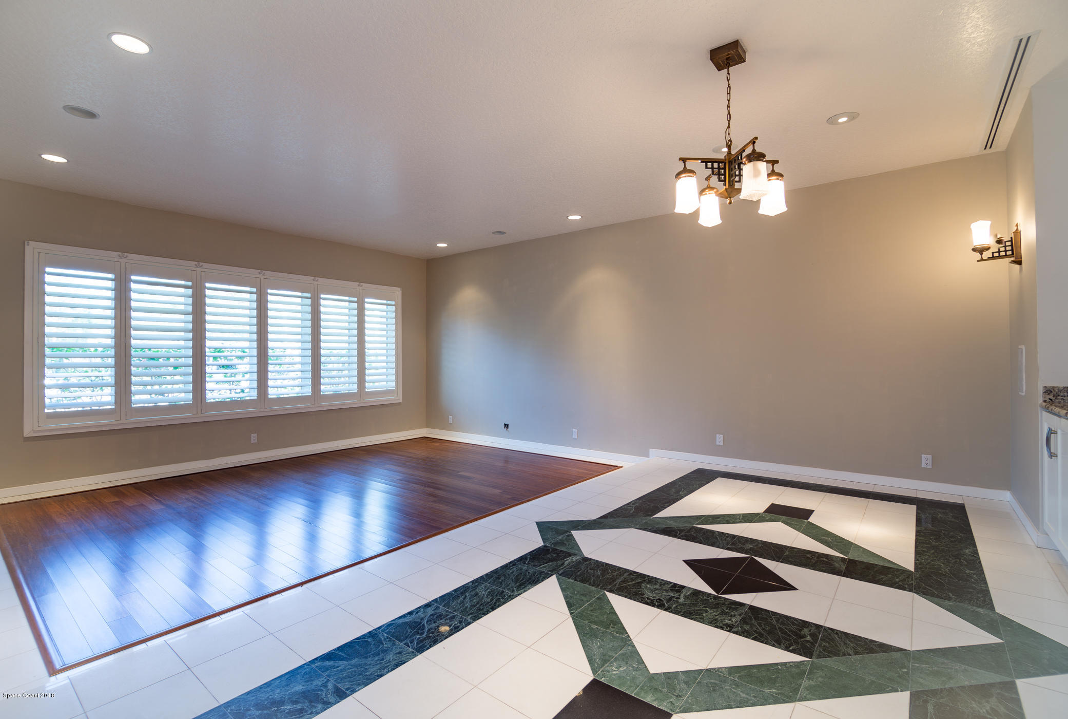 3081 Rio Baya North Melbourne, FL 32903 - Photo 12 of 31 a view of a room with a ceiling fan and wooden floor