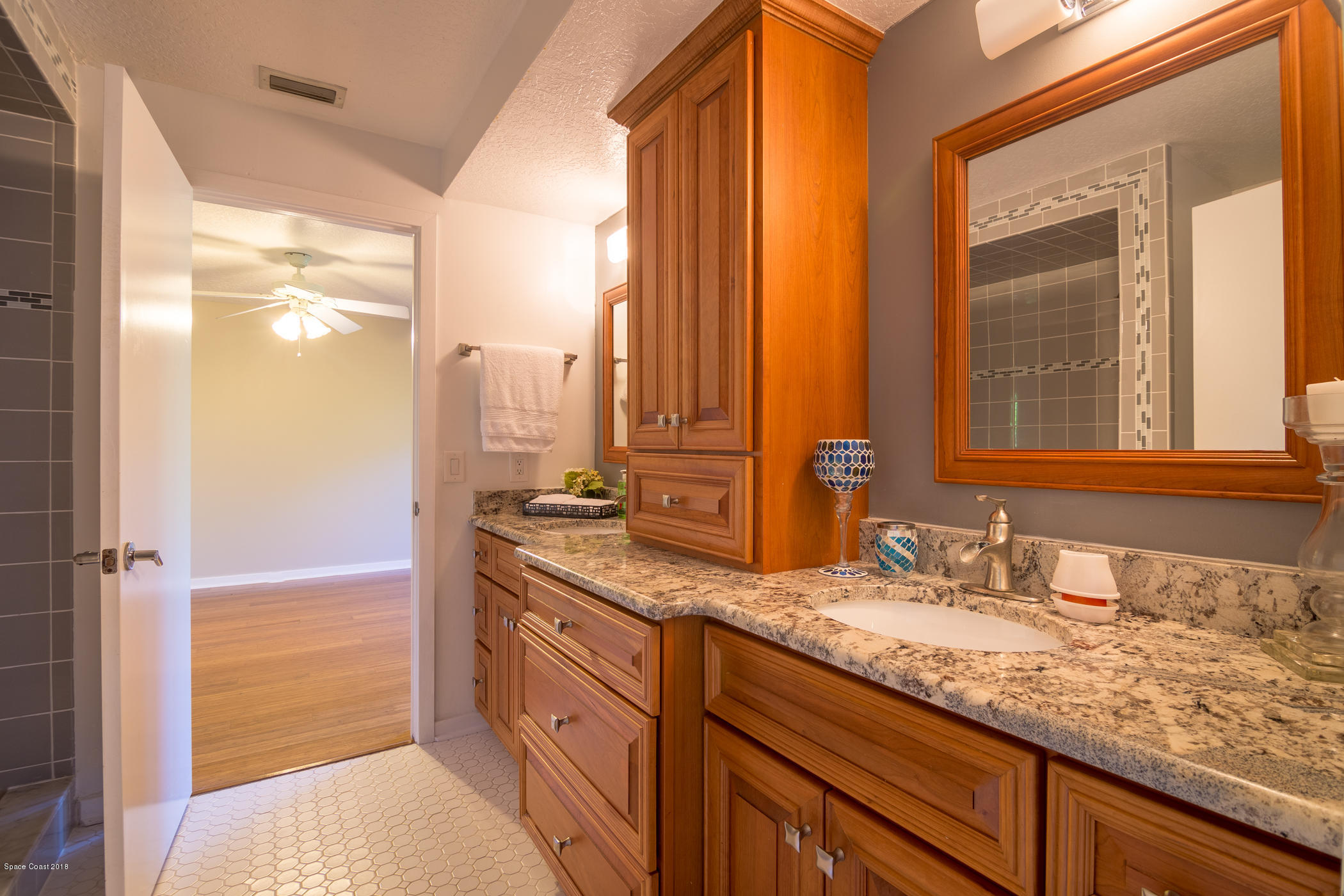 3081 Rio Baya North Melbourne, FL 32903 - Photo 18 of 31 a bathroom with a granite countertop sink and a mirror