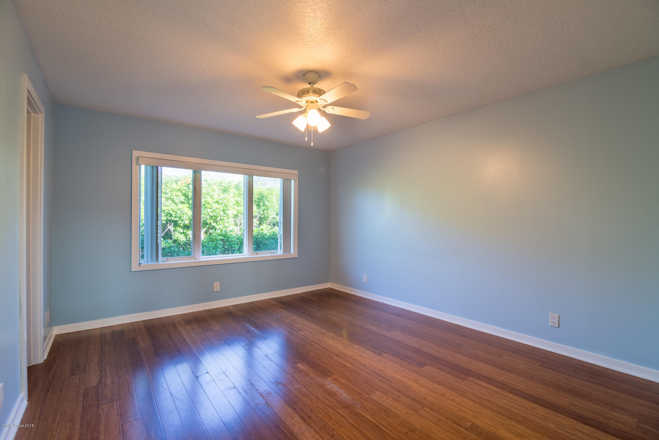 3081 Rio Baya North Melbourne, FL 32903 - Photo 19 of 31 a view of empty room with wooden floor and fan