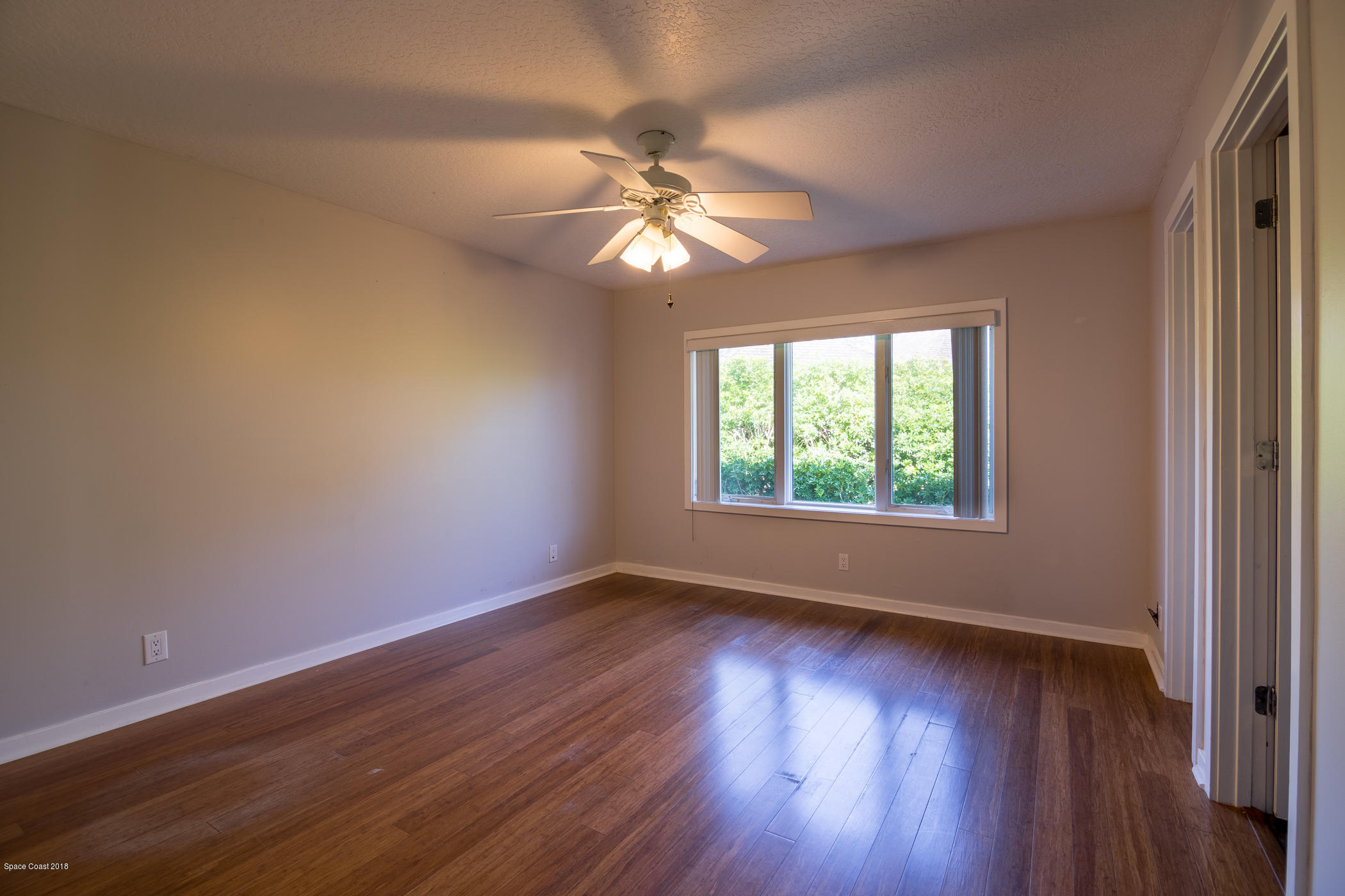 3081 Rio Baya North Melbourne, FL 32903 - Photo 20 of 31 a view of an empty room with wooden floor and a window