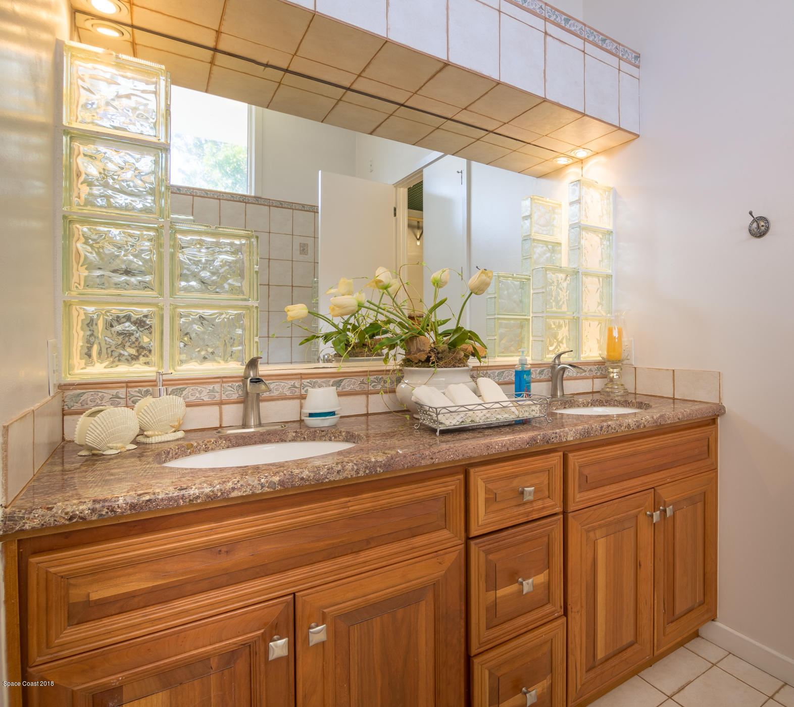 3081 Rio Baya North Melbourne, FL 32903 - Photo 24 of 31 a bathroom with a granite countertop sink and a large mirror