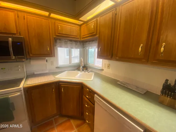 a kitchen with a sink and a refrigerator