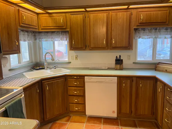 a kitchen with a refrigerator and cabinets