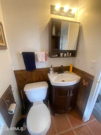a bed sitting in a spacious bedroom next to a window