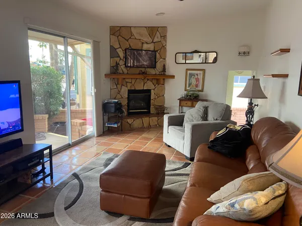a living room with furniture and a fireplace