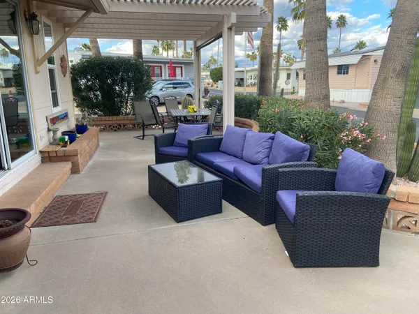 a backyard of a house with table and chairs